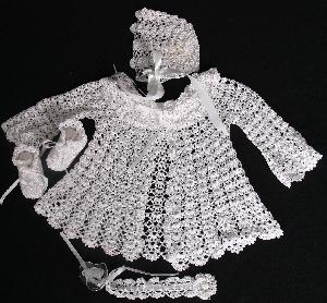 MOST DELICATE WHITE RAYON SET INCLUDES; BOOTIES, HAT, PACIFIER HOLDER AND SWEATER.  COULD BE WORN WITH DIAPER COVER, CELESTE CAPRI OR PANTYLOON.