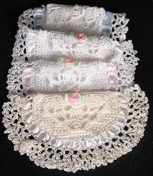 TREASURE POUCHES IN WHITE RAYON WITH DIFFERENT COLOR TRIM. POEM SAYS; PRETTY LITTLE CURLS AND TINY LITTLE TEETH, MANY BABY TREASURES FOR MOTHERS TO KEEP.