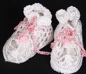 WHITE RAYON BOOTIE WITH TINY PINK POM POM AND CROCHETED TIE TRIM.   
