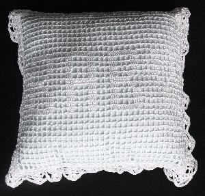 WHITE RAYON PILLOW IN FILET CROCHET WITH "BABY" SPELLED OUT.