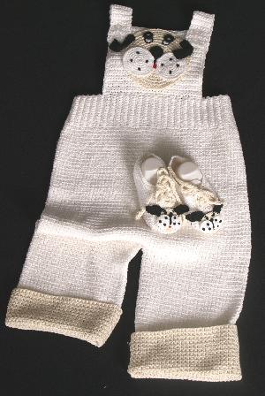 WHITE COTTON OVERALLS WITH DOGGIE FACE ON BIB, TRIMMED IN TAN AND BLACK.   