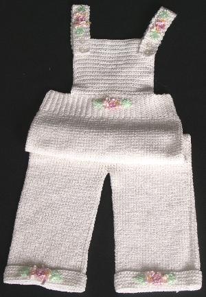 WHITE COTTON EMBELLISHED WITH PINK CLUSTER RIBBON FLOWERS. 
