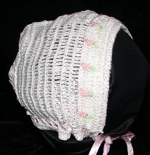 WHITE RAYON HAT WITH TINY PINK AND GREEN TULIPS AROUND THE COLLAR.