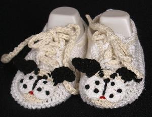 WHITE COTTON BOOTIE WITH DOGGIE FACE AND TRIMMED IN BLACK & BROWN.  