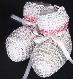 WHITE RAYON HIGH TOP BOOTIE WITH TEENY PINK AND GREEN FLOWER AND PINK STRIPE AROUND TOP.  ONE OF OUR LARGER BOOTIES.  