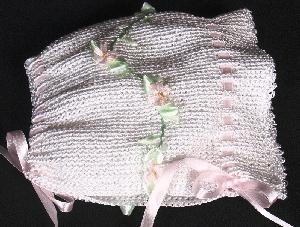 WHITET RAYON HAT WITH TINY PINK DAISIES AND GREEN RIBBON EMBELLISMENT.   