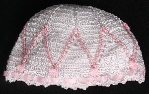 WHITE RAYON HAT WITH PINK EMBROIDERY DIAMOND DESIGN TRIM AND TINY PINK POM POMS.   
