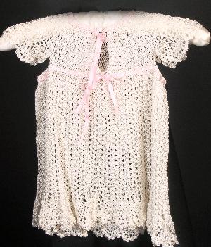 IVORY RAYON DRESS WITH LIGHT PINK RIBBON.  VERY VINTAGE AND SIMPLE, BACK SHOWN.  COULD BE WORN LONGER OVER PANTYLOONS OR JEANS.