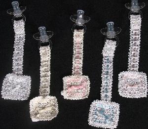 WHITE OR IVORY RAYON WITH DIFFERENT COLOR RIBBON.  OUR MOST POPULAR PACIFIER HOLDER BECAUSE OF ITS VERSATILITY.   
