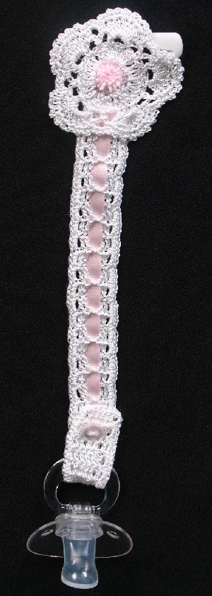 WHITE RAYON WITH PINK TRIM AND TINY PINK POM POM.  