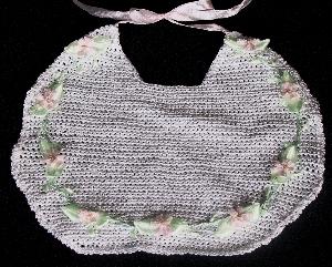 WHITE RAYON WITH TINY PINK DAISIES AND GREEN RIBBON TRIM.   