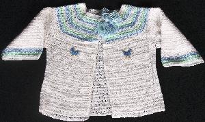 WHITE COTTON WITH BLUE AND GREEN TRIM AND LITTLE BLUE CHICS.  