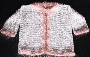 WHITE RAYON WITH FUZZY PINK TRIM.  