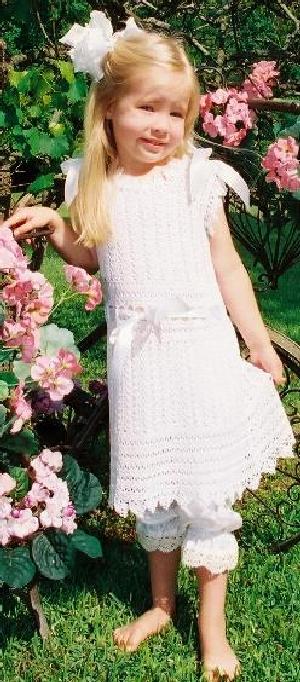 WHITE RAYON VINTAGE DRESS.  A VERY OLD PATTERN WITH A DROP WAIST AND RIBBON THAT ACCOMODATES A LARGE RANGE OF SIZES.  WORN BEAUTIFULLY OVER PANTYLOONS.