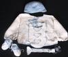 WHITE COTTON WITH BLUE TRIM INCLUDES; BOOTIES, HAT, PACIFIER HOLDER, BIB AND SWEATER. ALSO AVAILABLE WHITE DIAPER COVER OR STRIPED BOTTOM.