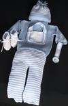 WHITE COTTON WITH BLUE TRIM STRIPES. SET INCLUDES; BOOTIES, HAT, PACIFIER HOLDER, BIB, STRIPED BOTTOM AND FLAP SWEATER.