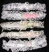 WHITE RAYON HEADBANDS WITH DIFFERENT COLOR ROSETTES WITH GREEN LEAVES.
POEM READS, "WEAR AS A HALO UPON BABY'S HEAD, CHERISH AS A GARTER TILL THE DAY SHE WEDS."