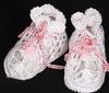WHITE RAYON BOOTIE WITH TINY PINK POM POM AND CROCHETED TIE TRIM.   