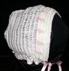 WHITE RAYON HAT WITH TINY PINK AND GREEN TULIPS AROUND THE COLLAR.
