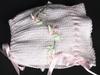 WHITET RAYON HAT WITH TINY PINK DAISIES AND GREEN RIBBON EMBELLISMENT.   