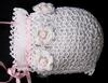 WHITE RAYON HAT WITH WHITE CROCHET FLOWERS WITH TINY PINK ROSEBUD CENTERS WITH GREEN LEAVES.  