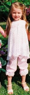 WHITE OR IVORY RAYON DRESS. A FAVORITE BECAUSE OF THE LONG TERM WEARABILITY, JUST TIGHTEN THE RIBBONS AT THE SLEEVE, BODICE AND NECK, ADD PANTYLOONS FOR LARGER SIZES.