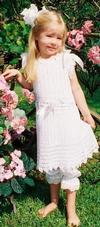 WHITE RAYON VINTAGE DRESS. A VERY OLD PATTERN WITH A DROP WAIST AND RIBBON THAT ACCOMODATES A LARGE RANGE OF SIZES. WORN BEAUTIFULLY OVER PANTYLOONS.